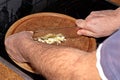 Chef slicing garlic Allium sativum on the cutting board with a knife