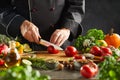 Chef slicing salad ingredients in a restaurant