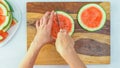 Chef slicing watermelon on wooden cutting board Royalty Free Stock Photo