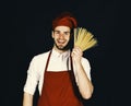 Chef with smiling face holds bunch of spaghetti Royalty Free Stock Photo