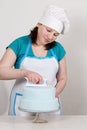 Chef smoothes mastic on the cake Royalty Free Stock Photo