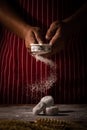 Chef spreading flour on bakery prepare for baking. Cook showing Royalty Free Stock Photo