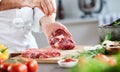 Chef sprinkling cooking salt on a raw ribeye steak Royalty Free Stock Photo