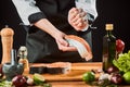 Chef squeezing lime over salmon steak. Cooking delicious fish dish Royalty Free Stock Photo