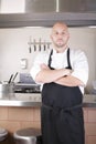 Chef Standing Next To Cooker In Kitchen