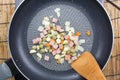 Chef stir fried slice of bacon and vegetable in pan Royalty Free Stock Photo