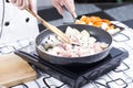 Chef stir-fried slice of pork in the pan for cooking Japanese po Royalty Free Stock Photo