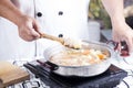 Chef stir-fried slice of pork in the pan for cooking Japanese po