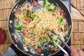 Chef stir fried Spaghetti with tongs Royalty Free Stock Photo