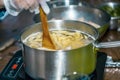 Chef stir Spaghetti in a pot of boiling water. cooking spaghetti.