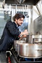 Chef stirring a huge pot of stew or casserole