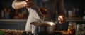 The chef stirring a rich sauce in a modern kitchen environment..AI generated image Royalty Free Stock Photo