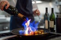 chef streaming wine into a pan, igniting a blue flame