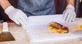 Chef at a street market preparing sandwich with grilled melted cheese and bacon Royalty Free Stock Photo