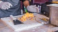 Chef at a street market preparing sandwich with grilled melted cheese and bacon Royalty Free Stock Photo