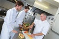 chef supervising trainees cooking Royalty Free Stock Photo