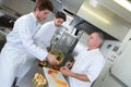 Chef supervising trainees cooking Royalty Free Stock Photo