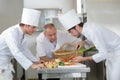 Chef supervising trainees cooking Royalty Free Stock Photo