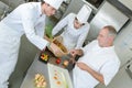 Chef supervising trainees cooking Royalty Free Stock Photo