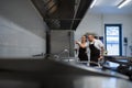 Chef teaching cook how to use combi oven indoors in restaurant kitchen. Royalty Free Stock Photo