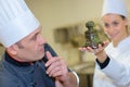 Chef team in restaurant kitchen with dessert working together Royalty Free Stock Photo