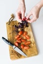 The chef tears off the leaves of basalica. Top view, white background.