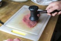 Chef tenderizing meat before cooking it Royalty Free Stock Photo