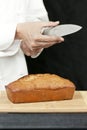 Chef Tests Knife Sharpness Over Banana Bread Royalty Free Stock Photo