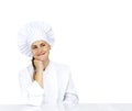 Chef thinking looking smiling and happy to the side. Woman chef, cook or baker in chef uniform and hat.