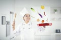 Chef throws food ingredients in a frying pan Royalty Free Stock Photo