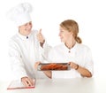Chef with thumb up examining cook Royalty Free Stock Photo