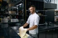 Chef tossing dough in air while making pizza base Royalty Free Stock Photo