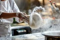 chef tossing pizza dough in a commercial kitchen setting Royalty Free Stock Photo