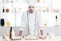 Chef in uniform is ready to make a dough in kitchen. Royalty Free Stock Photo