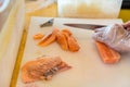 Chef use knife preparing a fresh salmon on a cutting board, Japanese chef in restaurant slicing raw salmon, ingredient for seafood Royalty Free Stock Photo