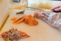 Chef use knife preparing a fresh salmon on a cutting board, Japanese chef in restaurant slicing raw salmon, ingredient for seafood Royalty Free Stock Photo