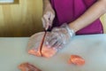 Chef use knife preparing a fresh salmon on a cutting board, Japanese chef in restaurant slicing raw salmon, ingredient for seafood Royalty Free Stock Photo