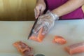 Chef use knife preparing a fresh salmon on a cutting board, Japanese chef in restaurant slicing raw salmon, ingredient for seafood Royalty Free Stock Photo