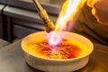 chef using a blowtorch to caramelize a crme brle Royalty Free Stock Photo