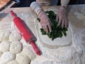 Chef using bread roller to roll dough evenly Royalty Free Stock Photo