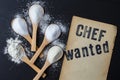Chef wanted, written on vintage yellowed paper, next to 5 bamboo wooden teaspoons