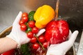 Chef washing bell peppers and cherry tomatoes.