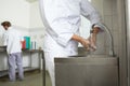 Chef washing hands prior to cook Royalty Free Stock Photo