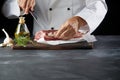 Chef cutting lamb chop with knife on cutting board Royalty Free Stock Photo