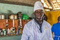 Portrait of young black male African chef cooking in the restaurant kitchen.