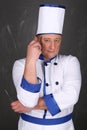 Chef wearing workwear, holding knife and fork Royalty Free Stock Photo