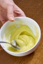 Chef whips yellow cream in a bowl by hand for making cheesecakes complete series of food recipes