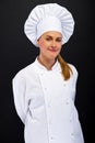 Chef woman over dark bacground standing