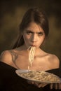Chef woman with red lips eat pasta. Diet and healthy organic food, italy. Woman eating pasta as taster or restaurant
