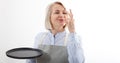 Chef woman showing sign for delicious. Female chef in uniform with perfect sign holding empty plate. Satisfied chef Royalty Free Stock Photo